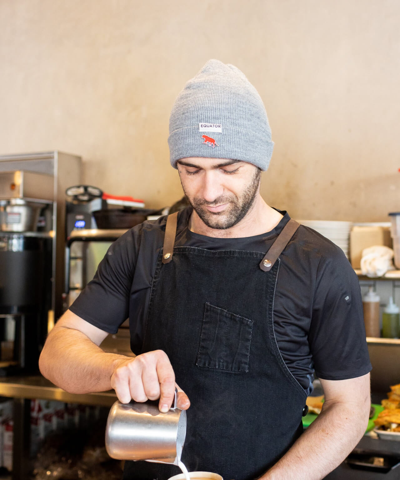 Equator Grey Tab Beanie | Grey Winter Beanie | Equator Barista wearing a grey beanie | Equator Coffees